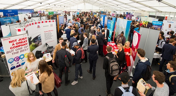 Careers Fair with lots of students talking to different employers on stands. Hosted in the Marquee